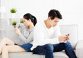 Couple sitting on couch and watching their phonesÃÂ  Royalty Free Stock Photo